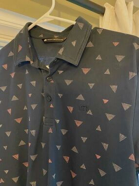 Travis Mathew Navy Polo with Pink & White Triangle Pattern